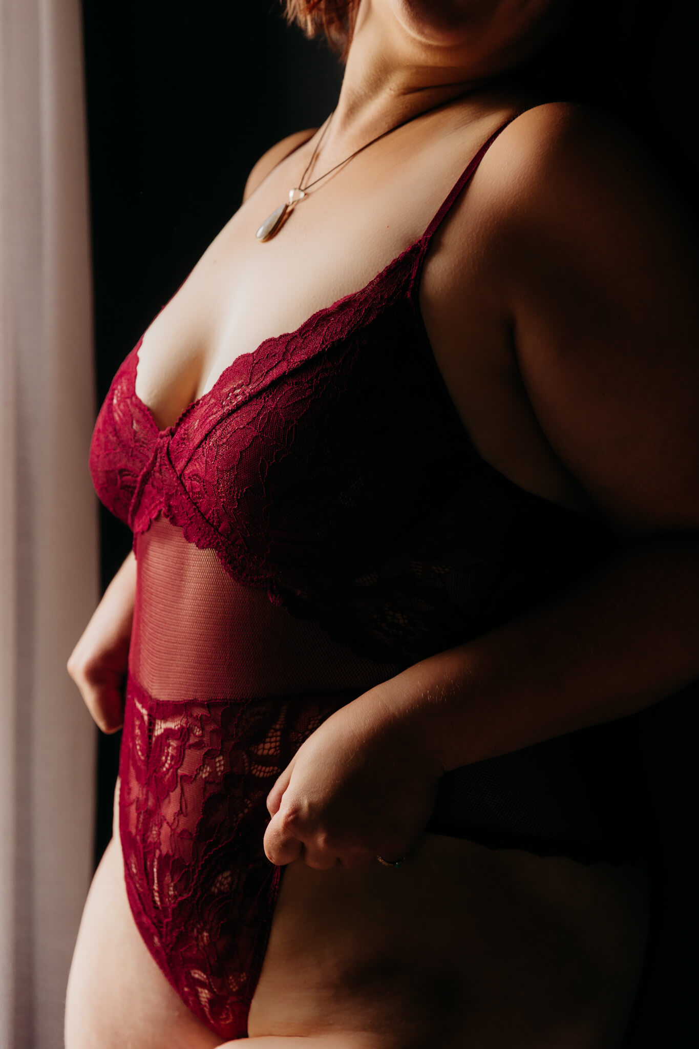 close up artistic image of a woman's red outfit and necklace